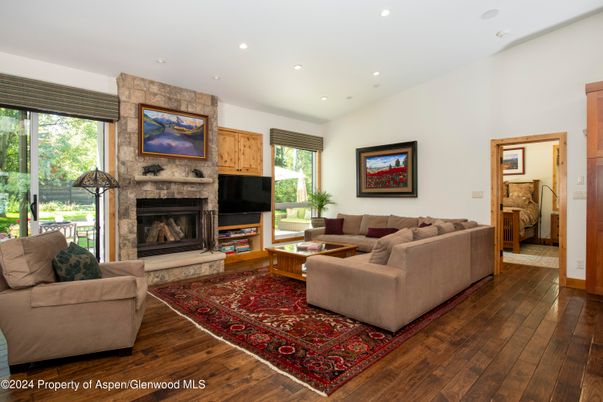 Fireplace, Interior, Living room, Recessed Lighting, Stone Walls, Wood Texture Flooring
