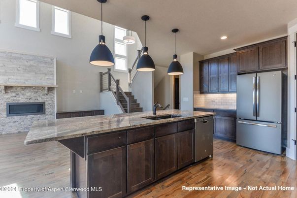 Fireplace, Interior, Kitchen, Pendant Lights, Recessed Lighting, Stainless Steel Appliances, Stone Walls, Wood Texture Flooring