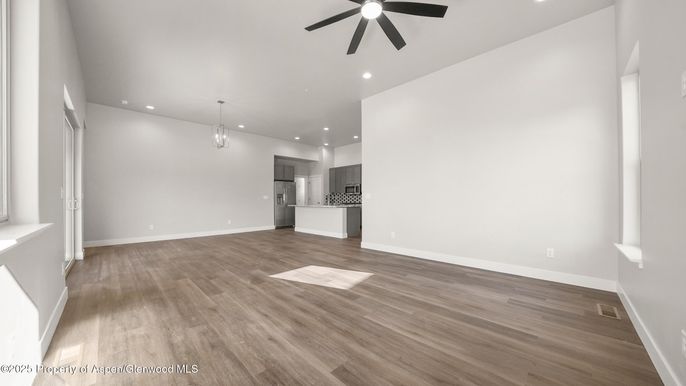 Empty room, Interior, Kitchen, Pendant Lights, Recessed Lighting, Stainless Steel Appliances, Wood Texture Flooring