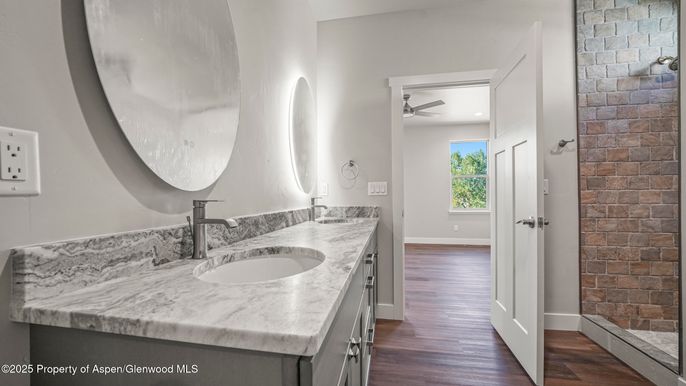Bathroom, Dual Sink Vanities, Interior, Recessed Lighting, Stone Walls, Wood Texture Flooring