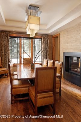 Dining room, Fireplace, Interior, Recessed Lighting, Stone Walls, Wood Texture Flooring