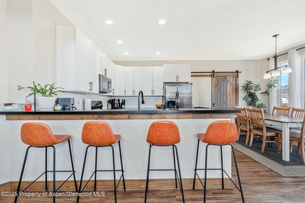 Dining room, Interior, Kitchen, Pendant Lights, Recessed Lighting, Stainless Steel Appliances, Wood Texture Flooring