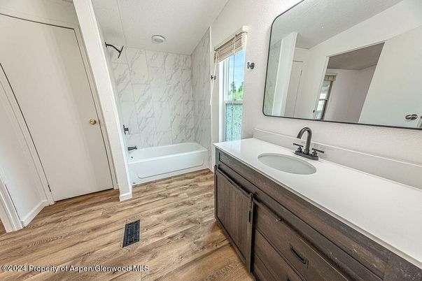 Bathroom, Dual Sink Vanities, Interior, Marble Walls, Wood Texture Flooring