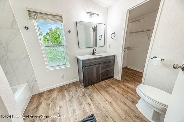 Bathroom, Dual Sink Vanities, Interior, Marble Walls, Wood Texture Flooring