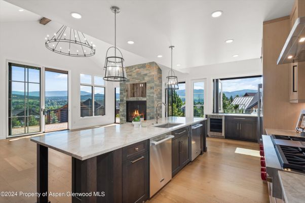 Fireplace, Interior, Kitchen, Pendant Lights, Recessed Lighting, Stainless Steel Appliances, Stone Walls, Wooden Beams, Wood Texture Flooring