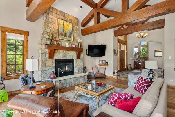 Chandelier, Fireplace, Interior, Living room, Stone Walls, Wooden Beams, Wood Texture Flooring