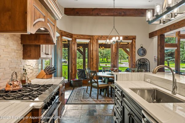 Chandelier, Dining room, Interior, Kitchen, Pendant Lights, Stainless Steel Appliances, Stone Walls, Wooden Beams