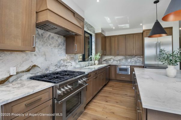 Interior, Kitchen, Marble Walls, Pendant Lights, Recessed Lighting, Stainless Steel Appliances, Wood Texture Flooring