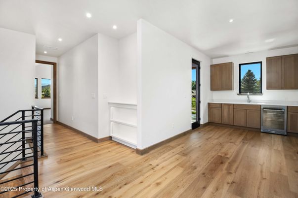Empty room, Interior, Kitchen, Recessed Lighting, Stainless Steel Appliances, Wood Texture Flooring
