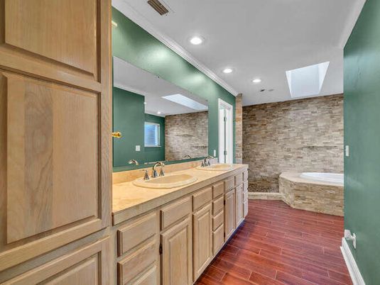 Bathroom, Dual Sink Vanities, Interior, Recessed Lighting, Stone Walls, Wood Texture Flooring