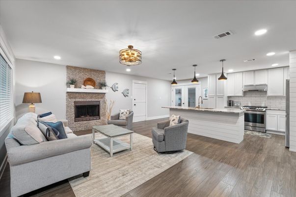 Fireplace, Interior, Kitchen, Living room, Pendant Lights, Recessed Lighting, Stainless Steel Appliances, Stone Walls, Wood Texture Flooring