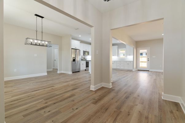 Chandelier, Empty room, Interior, Kitchen, Pendant Lights, Recessed Lighting, Stainless Steel Appliances, Wood Texture Flooring
