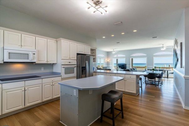 Dining room, Interior, Kitchen, Recessed Lighting, Stainless Steel Appliances, Water, Wood Texture Flooring