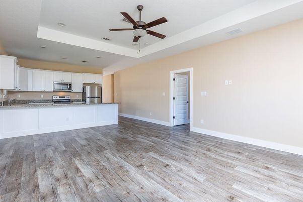 Empty room, Interior, Kitchen, Recessed Lighting, Stainless Steel Appliances, Wood Texture Flooring