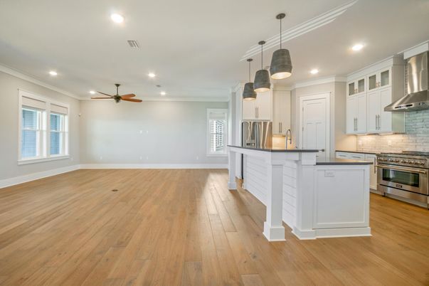 Empty room, Interior, Kitchen, Pendant Lights, Recessed Lighting, Stainless Steel Appliances, Wood Texture Flooring