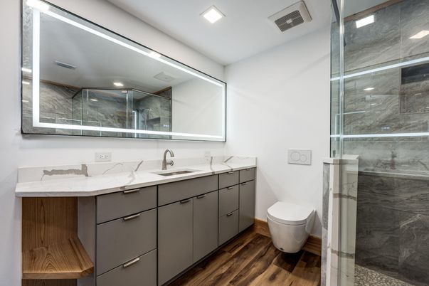 Bathroom, Dual Sink Vanities, Glass Shower, Interior, Marble Walls, Recessed Lighting, Wood Texture Flooring