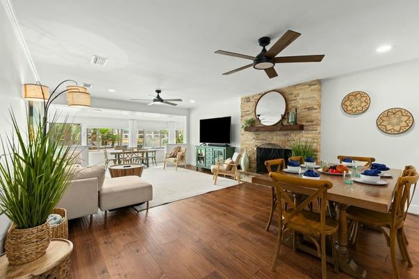 Dining room, Fireplace, Interior, Living room, Recessed Lighting, Stone Walls, Wood Texture Flooring