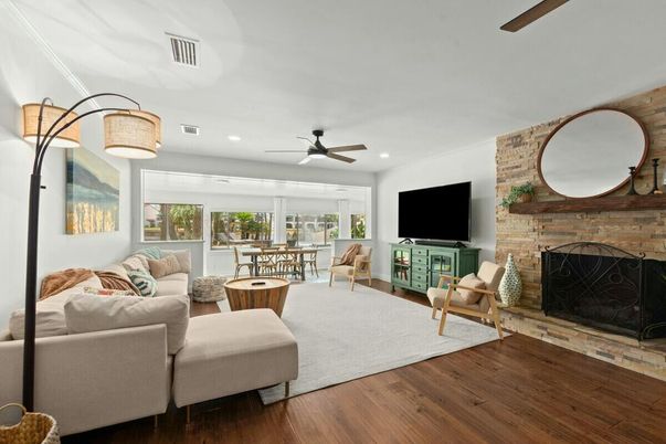 Dining room, Fireplace, Interior, Living room, Recessed Lighting, Stone Walls, Wood Texture Flooring