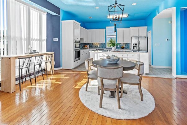 Chandelier, Dining room, Interior, Kitchen, Pendant Lights, Recessed Lighting, Stainless Steel Appliances, Wood Texture Flooring