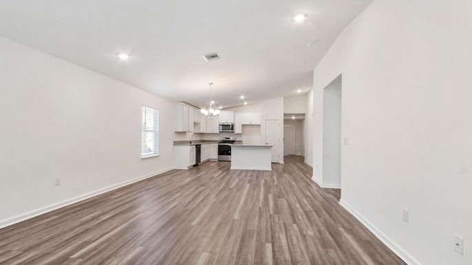 Chandelier, Empty room, Interior, Kitchen, Pendant Lights, Recessed Lighting, Stainless Steel Appliances, Wood Texture Flooring