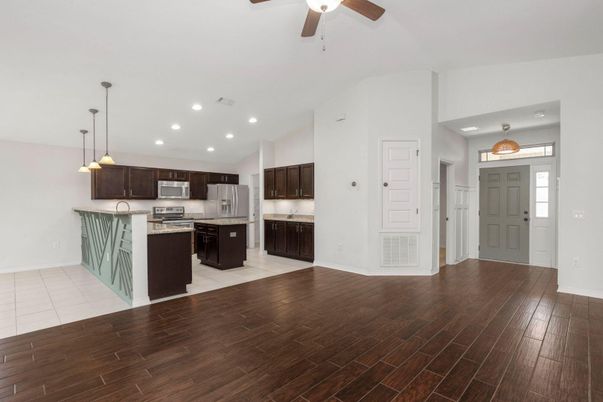 Empty room, Interior, Kitchen, Pendant Lights, Recessed Lighting, Stainless Steel Appliances, Wood Texture Flooring