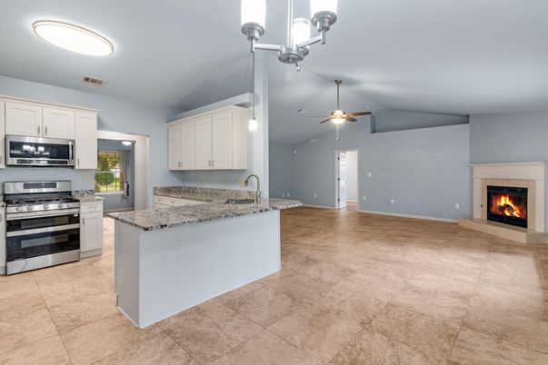 Empty room, Fireplace, Interior, Kitchen, Pendant Lights, Stainless Steel Appliances