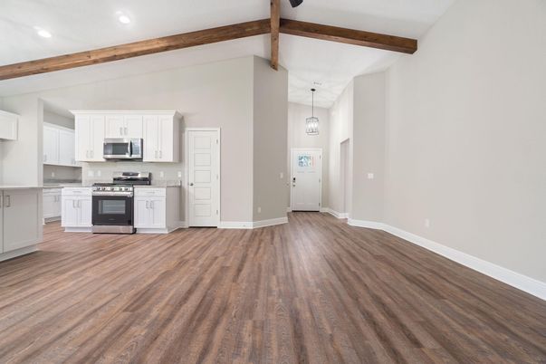 Empty room, Interior, Kitchen, Pendant Lights, Recessed Lighting, Stainless Steel Appliances, Wooden Beams, Wood Texture Flooring