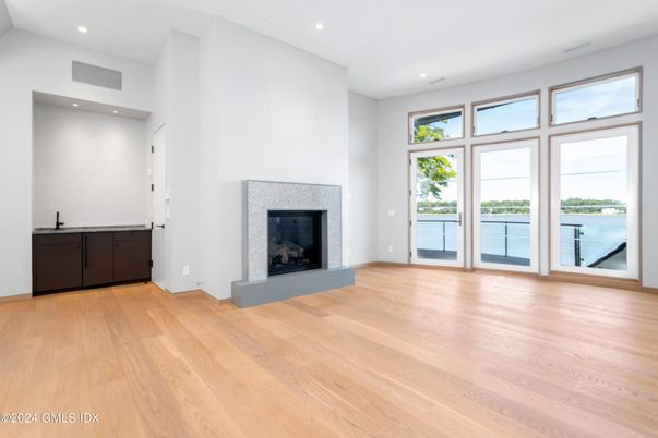 Empty room, Fireplace, Interior, Recessed Lighting, Water, Wood Texture Flooring