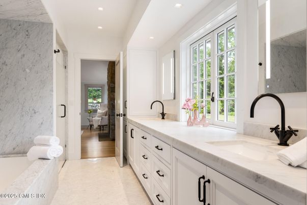Bathroom, Dual Sink Vanities, Interior, Marble, Marble Walls, Recessed Lighting, Wood Texture Flooring