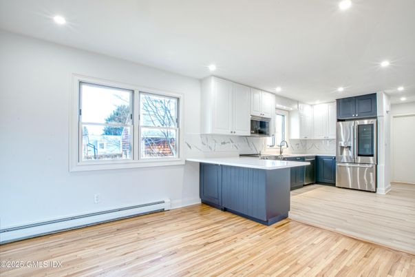 Interior, Kitchen, Marble Walls, Recessed Lighting, Stainless Steel Appliances, Wood Texture Flooring