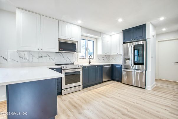 Interior, Kitchen, Marble Walls, Recessed Lighting, Stainless Steel Appliances, Wood Texture Flooring