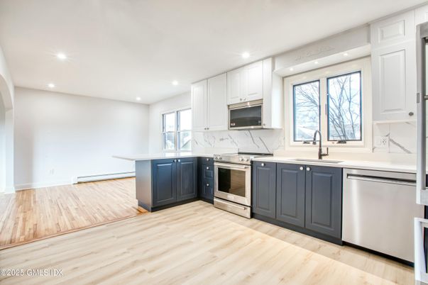 Interior, Kitchen, Marble Walls, Recessed Lighting, Stainless Steel Appliances, Wood Texture Flooring