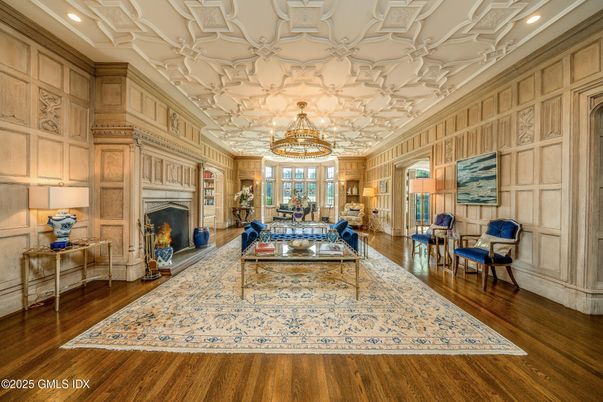 Chandelier, Fireplace, Interior, Living room, Recessed Lighting, Wood Texture Flooring, Wooden Walls