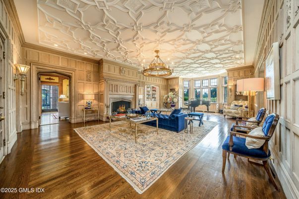 Chandelier, Fireplace, Interior, Living room, Recessed Lighting, Wood Texture Flooring, Wooden Walls