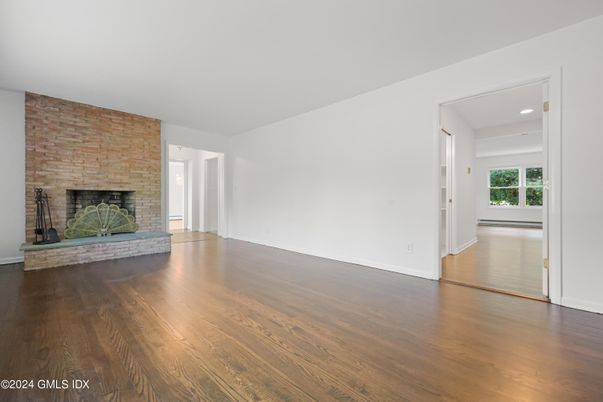 Empty room, Fireplace, Interior, Recessed Lighting, Stone Walls, Wood Texture Flooring