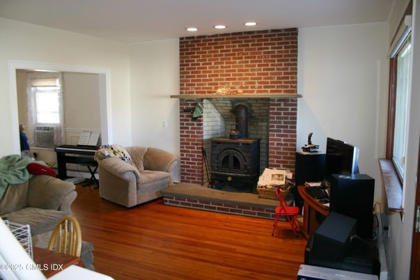 Fireplace, Interior, Living room, Piano, Recessed Lighting, Stone Walls, Wood Texture Flooring