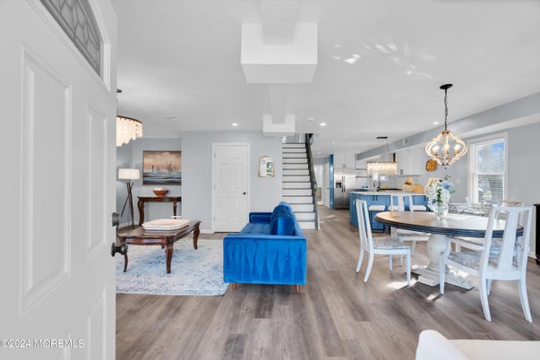 Chandelier, Dining room, Interior, Kitchen, Living room, Pendant Lights, Recessed Lighting, Stainless Steel Appliances, Wood Texture Flooring