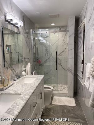 Bathroom, Dual Sink Vanities, Glass Shower, Interior, Marble, Marble Walls, Recessed Lighting