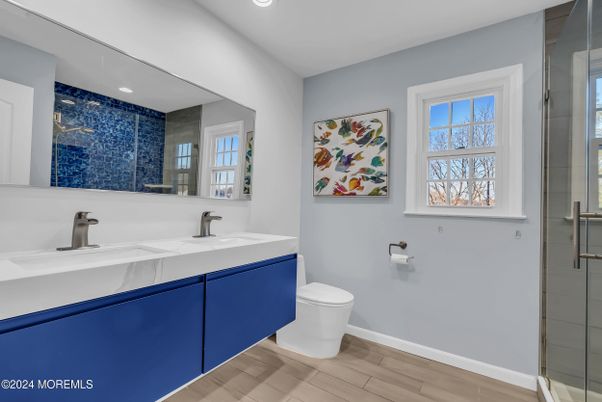 Bathroom, Dual Sink Vanities, Glass Shower, Interior, Recessed Lighting, Wood Texture Flooring