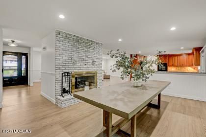 Dining room, Fireplace, Interior, Kitchen, Recessed Lighting, Stone Walls, Wood Texture Flooring