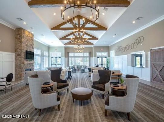 Chandelier, Fireplace, Interior, Living room, Recessed Lighting, Stone Walls, Wooden Beams