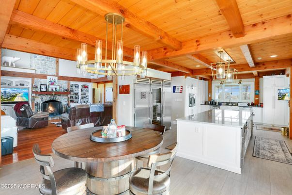 Chandelier, Dining room, Fireplace, Interior, Kitchen, Living room, Pendant Lights, Recessed Lighting, Stainless Steel Appliances, Wooden Beams, Wooden Ceilings, Wood Texture Flooring