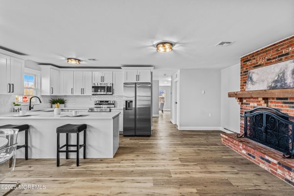 Fireplace, Interior, Kitchen, Stainless Steel Appliances, Stone Walls, Wood Texture Flooring