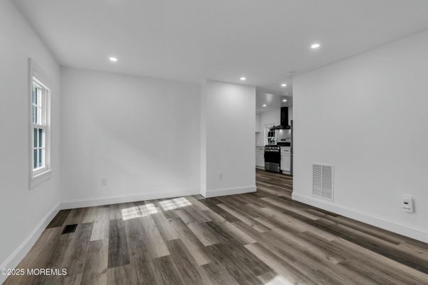 Empty room, Interior, Kitchen, Recessed Lighting, Stainless Steel Appliances, Wood Texture Flooring