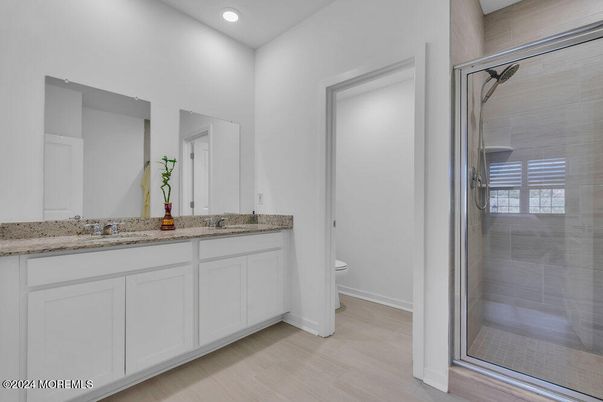 Bathroom, Dual Sink Vanities, Glass Shower, Interior, Recessed Lighting, Wood Texture Flooring