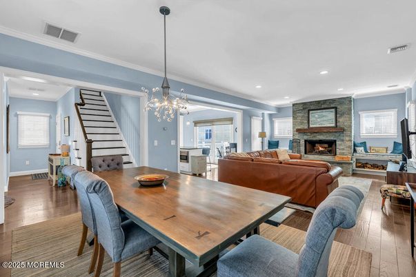 Chandelier, Dining room, Fireplace, Interior, Living room, Pendant Lights, Recessed Lighting, Wood Texture Flooring