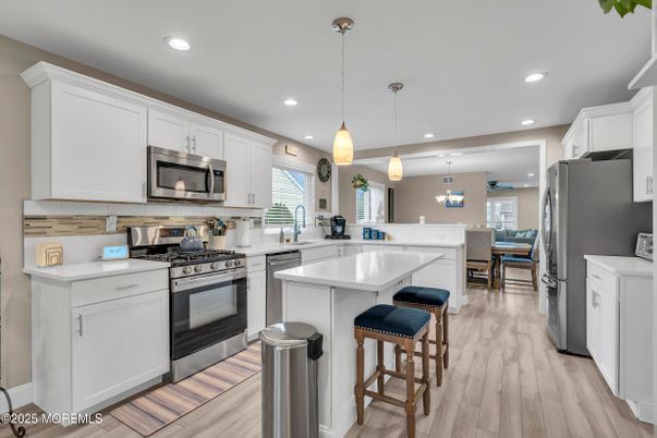 Dining room, Interior, Kitchen, Pendant Lights, Recessed Lighting, Stainless Steel Appliances, Wood Texture Flooring