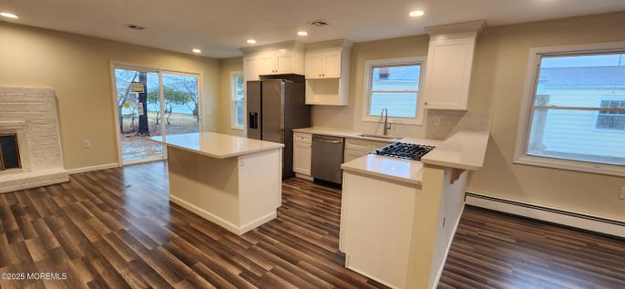 Fireplace, Interior, Kitchen, Recessed Lighting, Stainless Steel Appliances, Wood Texture Flooring