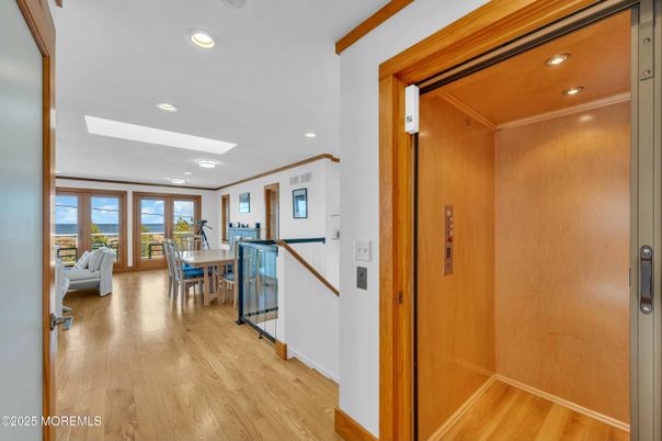 Dining room, Elevator, Interior, Recessed Lighting, Wood Texture Flooring, Wooden Walls