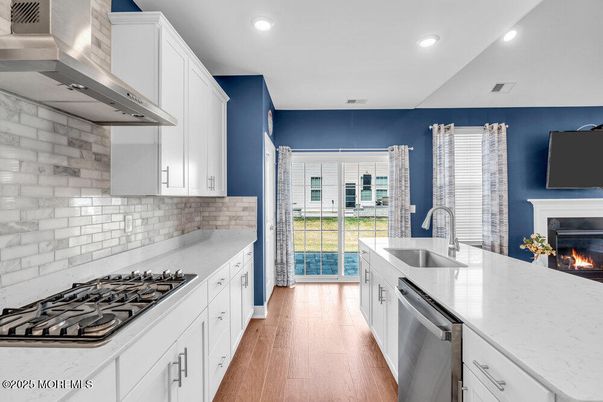 Fireplace, Interior, Kitchen, Recessed Lighting, Stainless Steel Appliances, Wood Texture Flooring